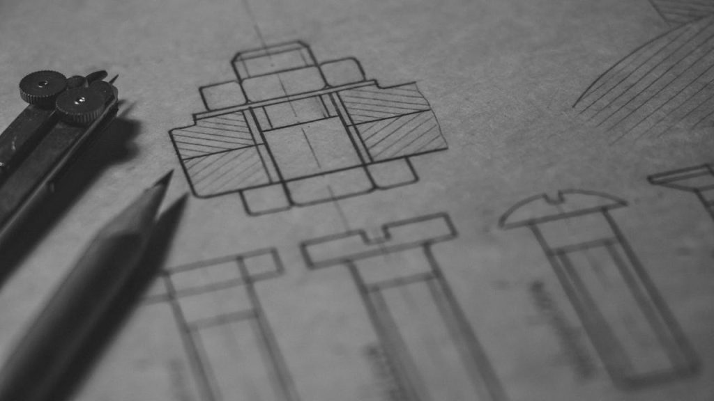 Detailed technical blueprint with pencil and compass illustrating engineering design concepts.